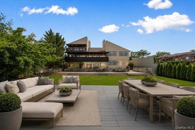 Set behind private gates on an oversized waterfront parcel, this - photo 1
