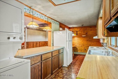 Tucked on a quiet lane under tall pines, this classic cabin - photo 12