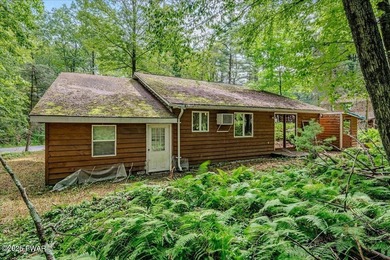 Tucked on a quiet lane under tall pines, this classic cabin - photo 22