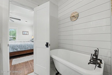 Nestled amongst majestic Live Oaks on one of Waveland's most - photo 15