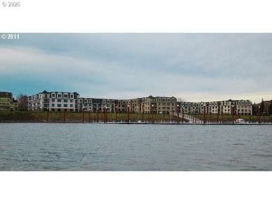 Experience elevated riverfront living in this top-floor