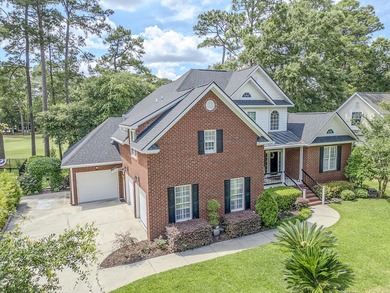 This stunning custom-built brick home in the prestigious gated - photo 3