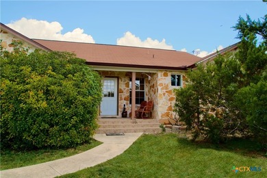 Nestled on a half-acre wooded lot in Rocky Creek Ranch, this - photo 1