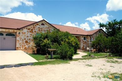 Nestled on a half-acre wooded lot in Rocky Creek Ranch, this - photo 2