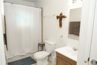 Nestled on a half-acre wooded lot in Rocky Creek Ranch, this - photo 9