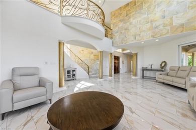 Welcome to this exquisite Spanish-style waterfront estate which