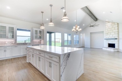 This stunning custom-built home presents a striking blend of - photo 3