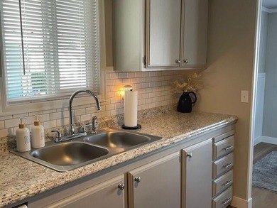 This roomy 1973 manufactured home sits on a quiet cul-de-sac in