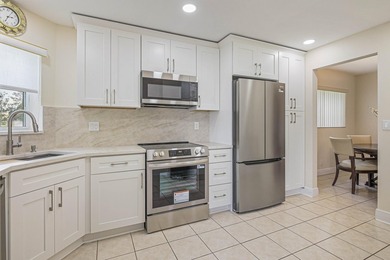 WELCOME TO THIS VERY DESIRABLE CORNER CONDO WITH BEAUTIFUL WATER - photo 6