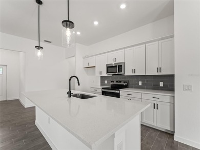 Tile throughout. Quartz countertops. Impact windows. Paver - photo 5
