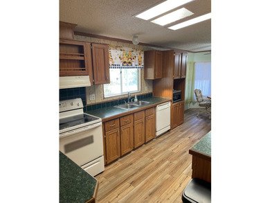 55+ community. This is a wonderful home with large living room - photo 10