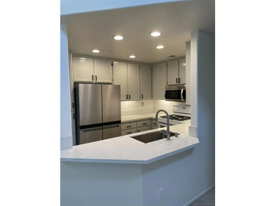 End unit in a private and quiet location overlooking trees in - photo 9