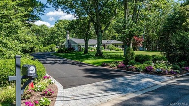 Nestled on two private, professionally landscaped acres in the - photo 1