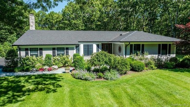 Nestled on two private, professionally landscaped acres in the - photo 2