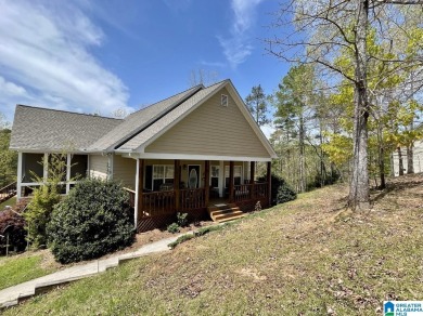 Located in a quiet and peaceful cove, this well-built home sits - Lake Home For Sale in Wedowee, Alabama