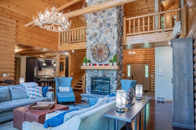 Sweeping lake views in this custom log retreat designed for - photo 3