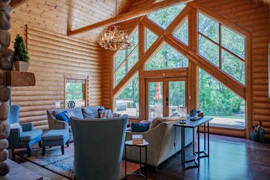 Sweeping lake views in this custom log retreat designed for - photo 5