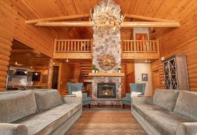 Sweeping lake views in this custom log retreat designed for - photo 6