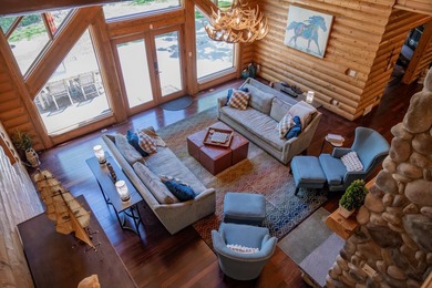 Sweeping lake views in this custom log retreat designed for - photo 7