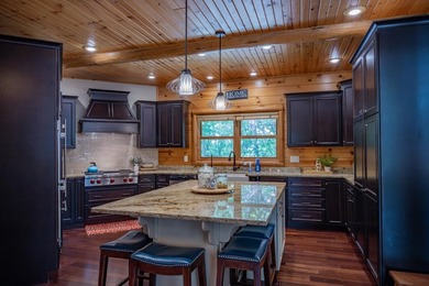 Sweeping lake views in this custom log retreat designed for - photo 8