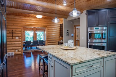 Sweeping lake views in this custom log retreat designed for - photo 9
