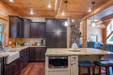 Sweeping lake views in this custom log retreat designed for - photo 10