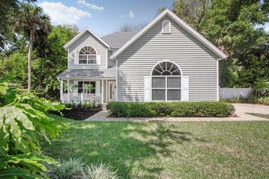 Tucked beneath a canopy of mature trees in the gated community - photo 4