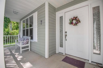 Tucked beneath a canopy of mature trees in the gated community - photo 5