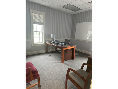 Three-story brick office building with 80% occupancy, offering