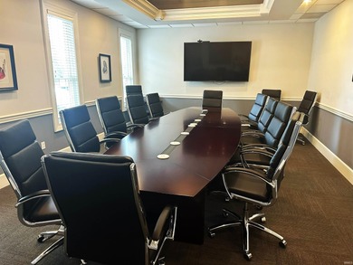 Three-story brick office building with 80% occupancy, offering