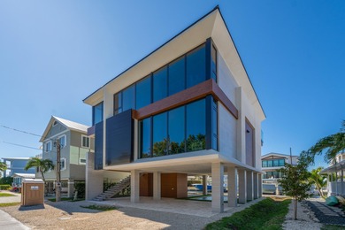 A striking new construction waterfront residence, offering a