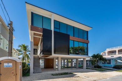 A striking new construction waterfront residence, offering a