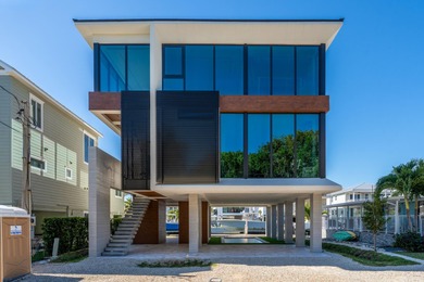 A striking new construction waterfront residence, offering a