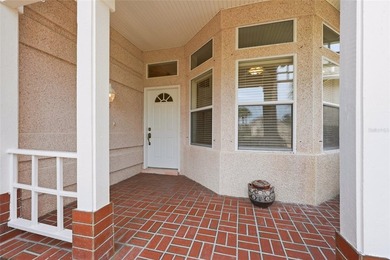 Welcome to easy coastal living in the highly sought-after gated - photo 2