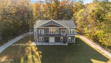 Situated on 1.48 acres of wooded land with stunning lake views - photo 3