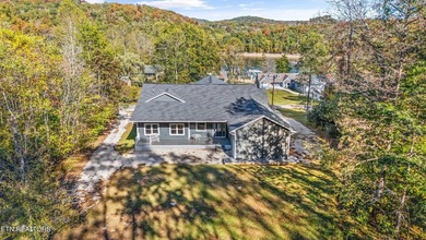 Situated on 1.48 acres of wooded land with stunning lake views - photo 6