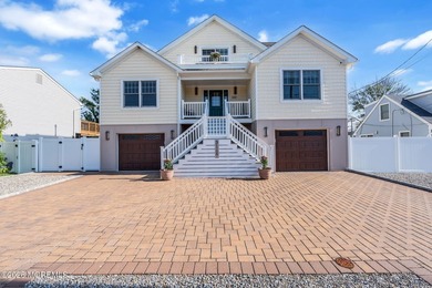 Custom-built in 2023 with water views, this meticulously - photo 1