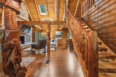 Discover lakeside living in this inviting log cabin on - photo 3