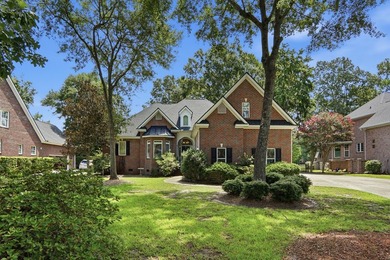Set among mature trees on a quiet street, this brick traditional - photo 2