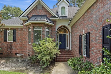 Set among mature trees on a quiet street, this brick traditional - photo 3