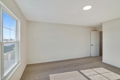Enjoy the New Year in this move-in-ready end-unit Adler townhome
