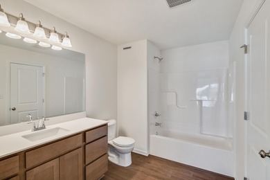 Enjoy the New Year in this move-in-ready end-unit Adler townhome
