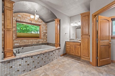 Well-maintained no-step home on a wooded cul-de-sac lot with