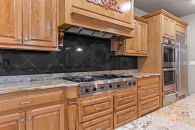 Well-maintained no-step home on a wooded cul-de-sac lot with