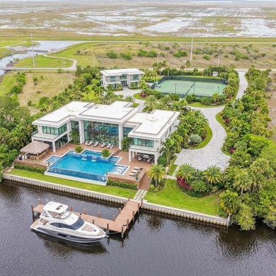 Set along 5+ pristine acres on the storied St. Lucie River, this - photo 2