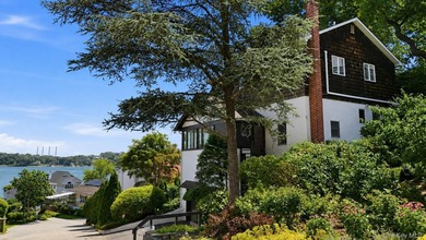 Nestled into the hillside with water views that hold through - photo 1