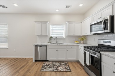 Nestled inside a desirable gated community, this beautifully