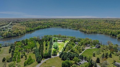 PRICE REDUCED! Exceptional lakefront retreat on nearly 5 private - photo 1