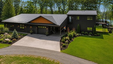 PRICE REDUCED! Exceptional lakefront retreat on nearly 5 private - photo 3