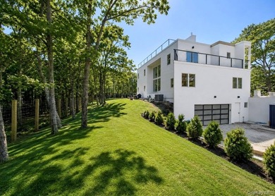 Set on 1.25 professionally landscaped acres bordering protected - photo 4